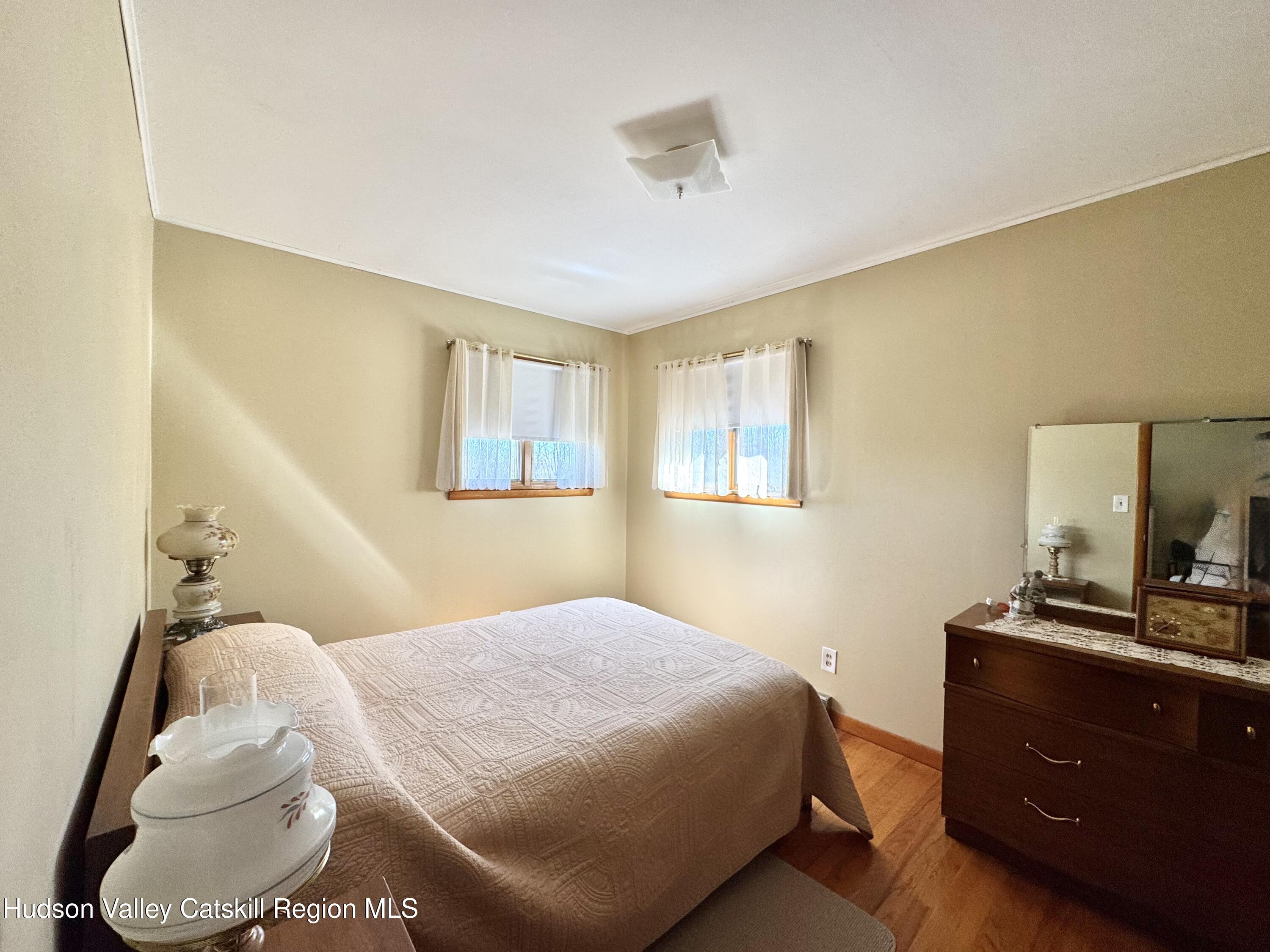 6339-6347 Highway 32 Catskill, NY 12413 - Photo 22 of 35 a bedroom with a bed and a dresser