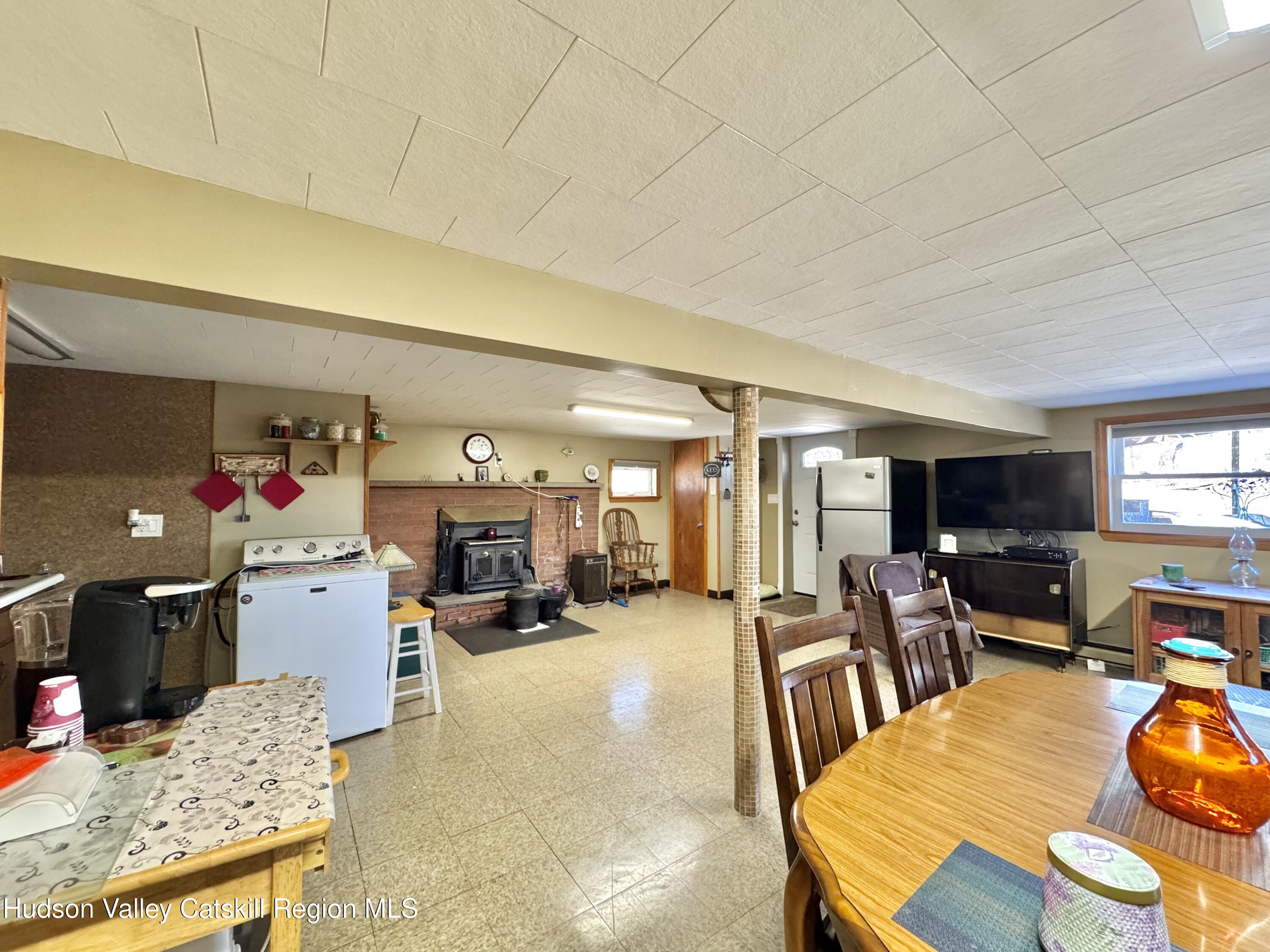 6339-6347 Highway 32 Catskill, NY 12413 - Photo 5 of 35 a living room with furniture and a dining table with kitchen view