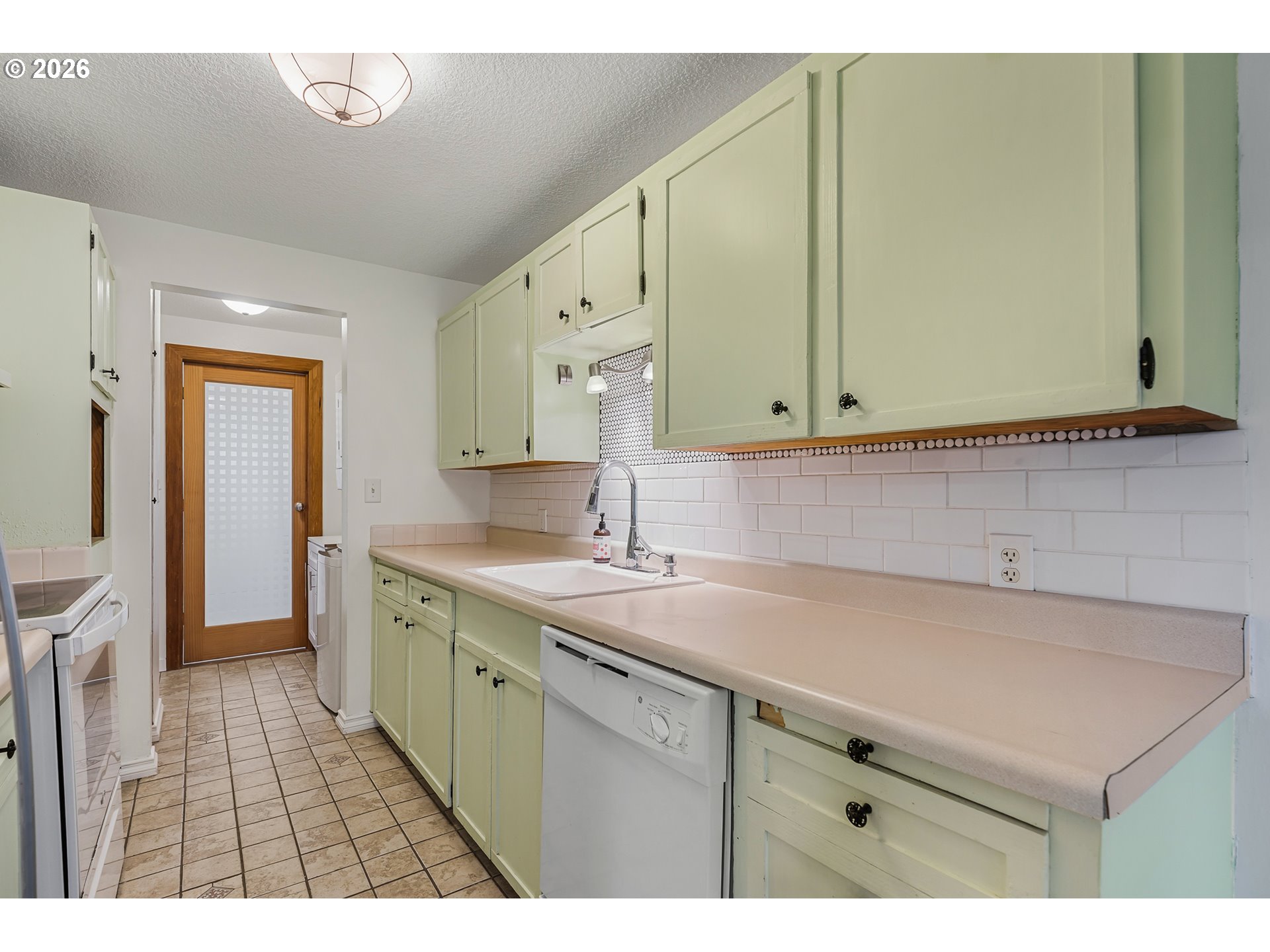 5566 Southwest Erickson Avenue Beaverton, OR 97005 - Photo 12 of 31 a kitchen with a sink cabinets and a window