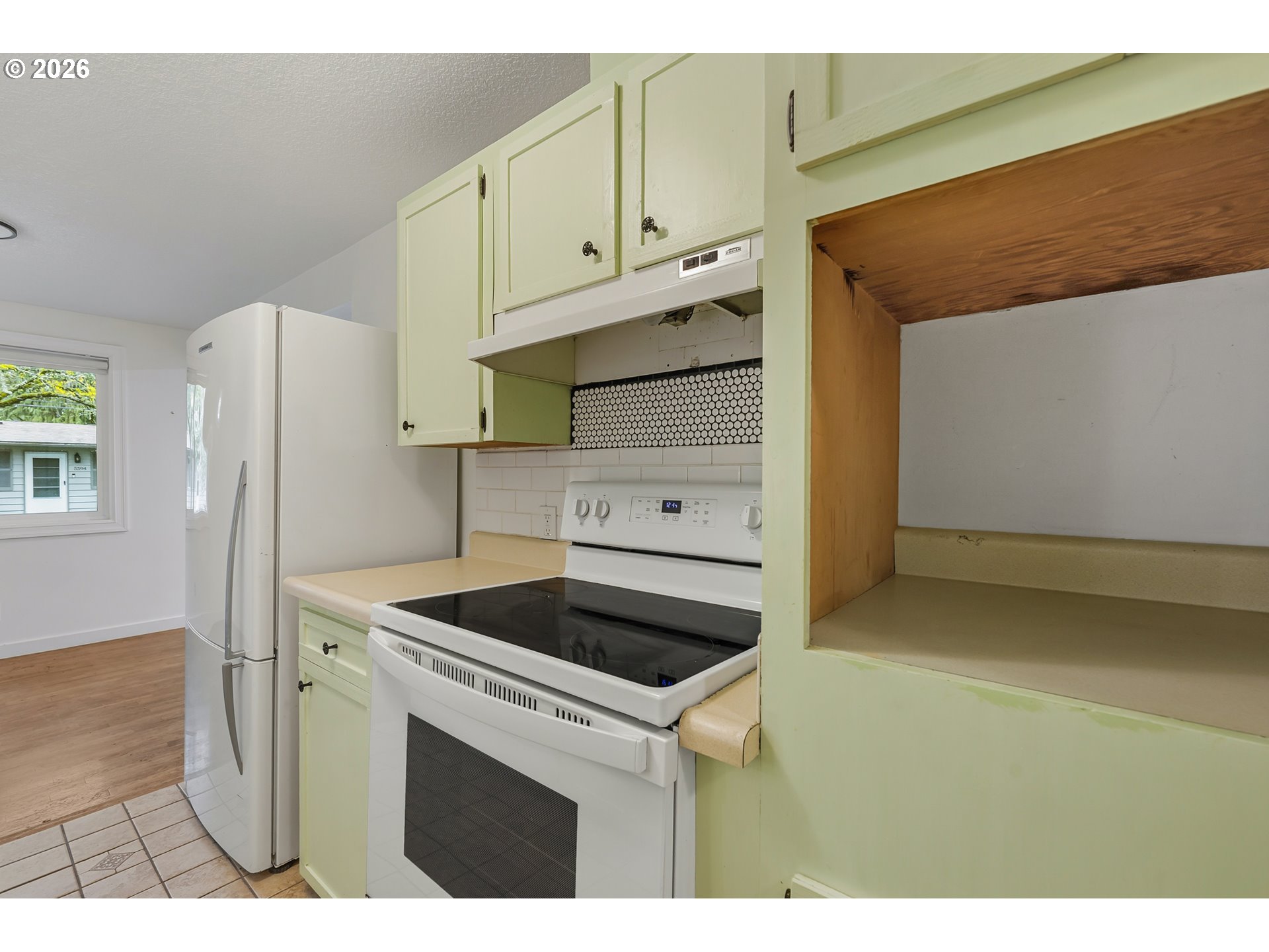 5566 Southwest Erickson Avenue Beaverton, OR 97005 - Photo 15 of 31 a kitchen with cabinets and a refrigerator