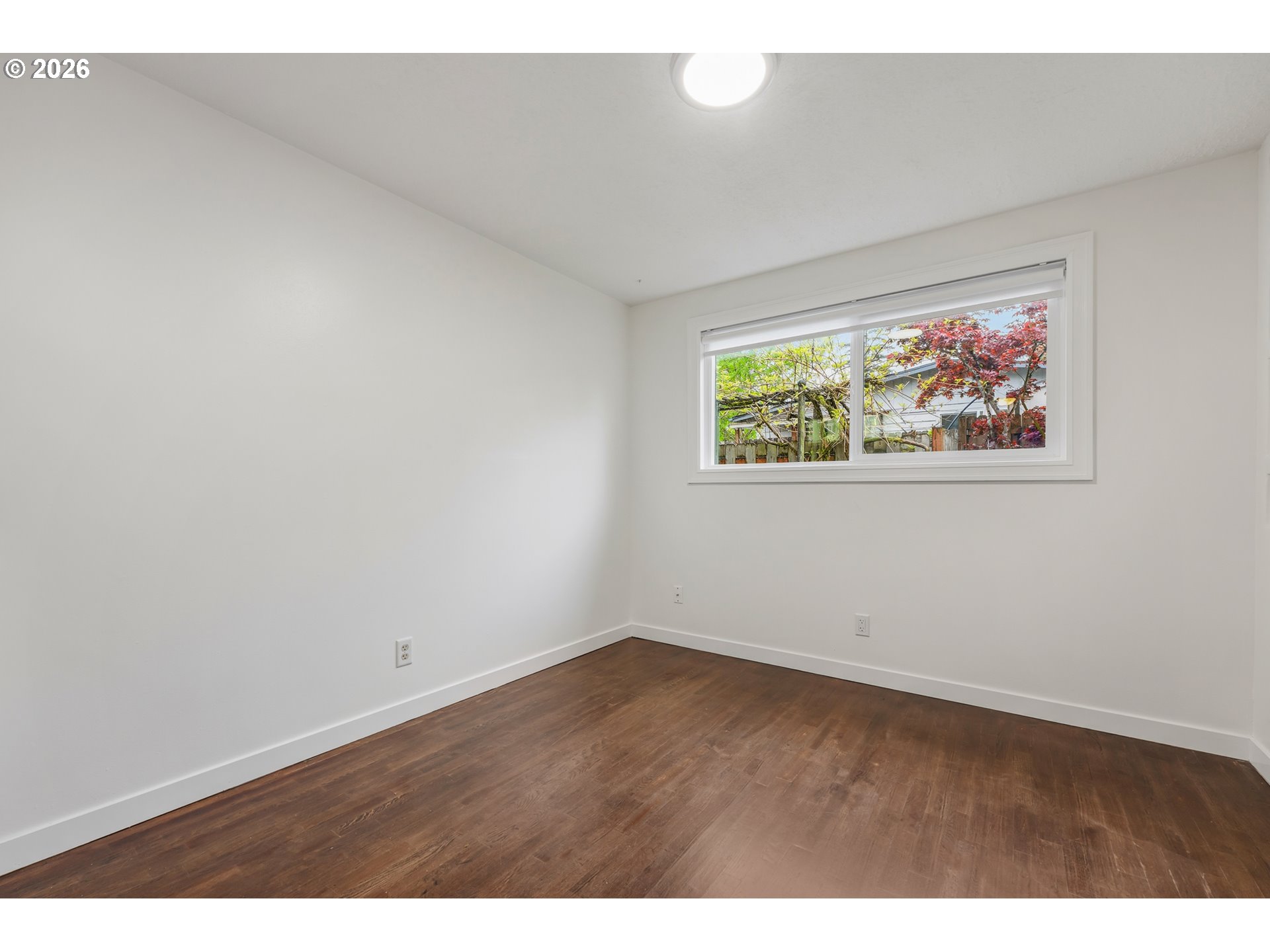 5566 Southwest Erickson Avenue Beaverton, OR 97005 - Photo 16 of 31 an empty room with wooden floor and windows