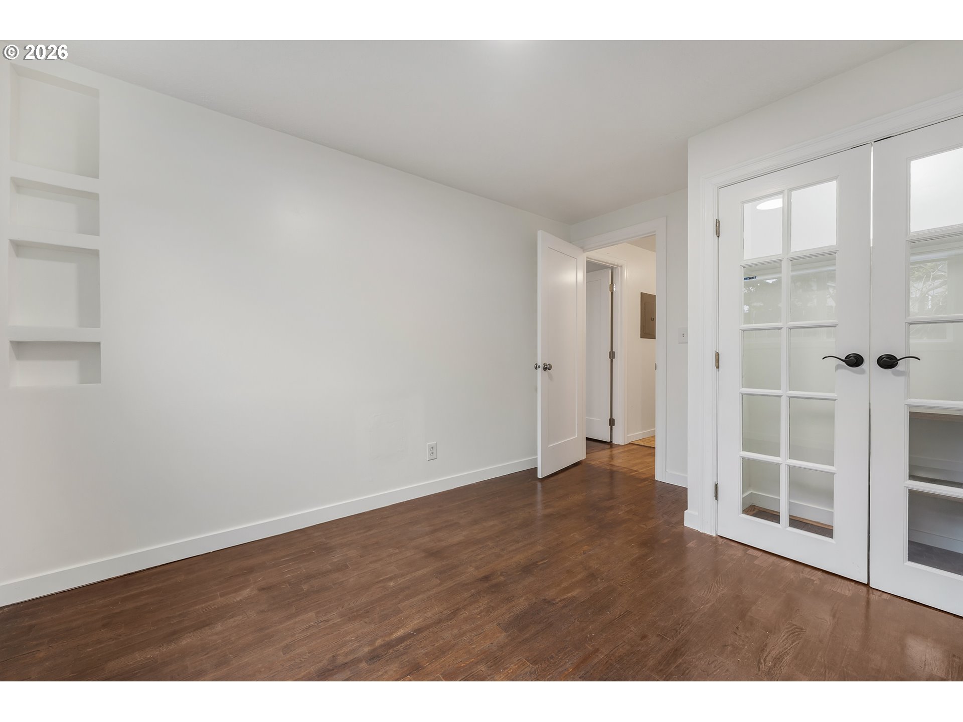 5566 Southwest Erickson Avenue Beaverton, OR 97005 - Photo 17 of 31 a view of an empty room with wooden floor and windows