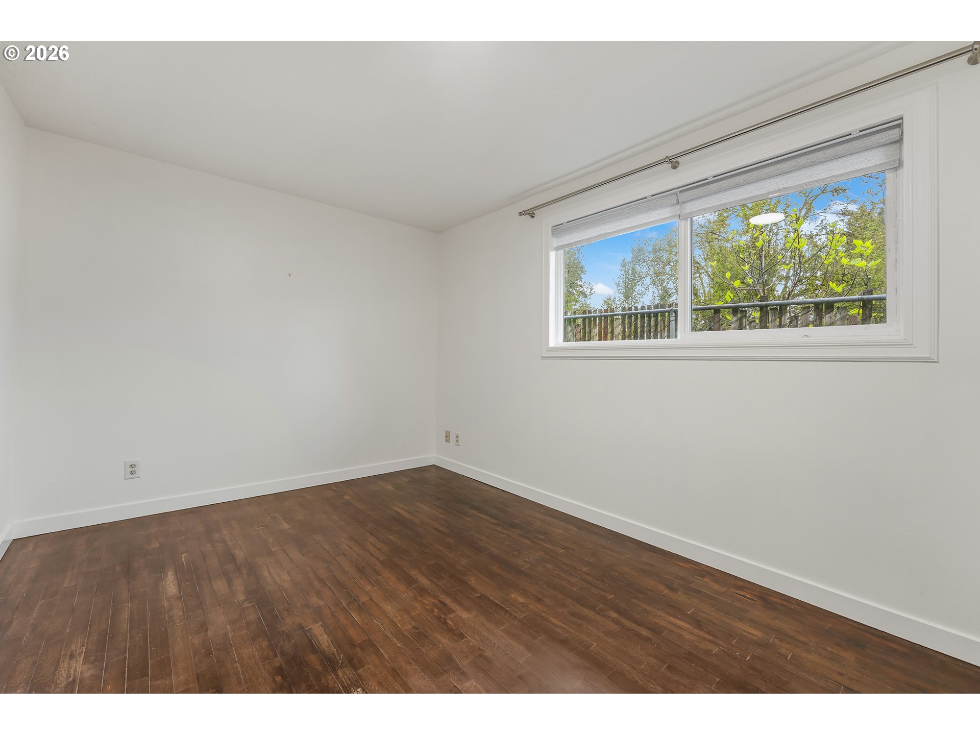 5566 Southwest Erickson Avenue Beaverton, OR 97005 - Photo 18 of 31 an empty room with wooden floor and windows