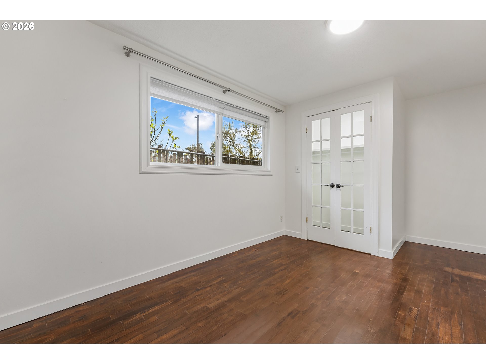 5566 Southwest Erickson Avenue Beaverton, OR 97005 - Photo 19 of 31 an empty room with wooden floor and windows
