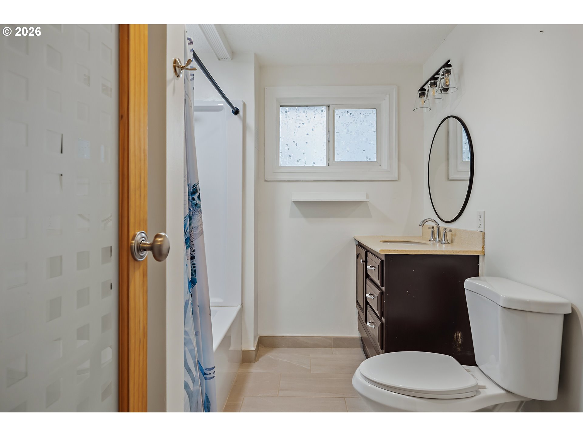 5566 Southwest Erickson Avenue Beaverton, OR 97005 - Photo 23 of 31 a bathroom with a toilet a sink and a mirror