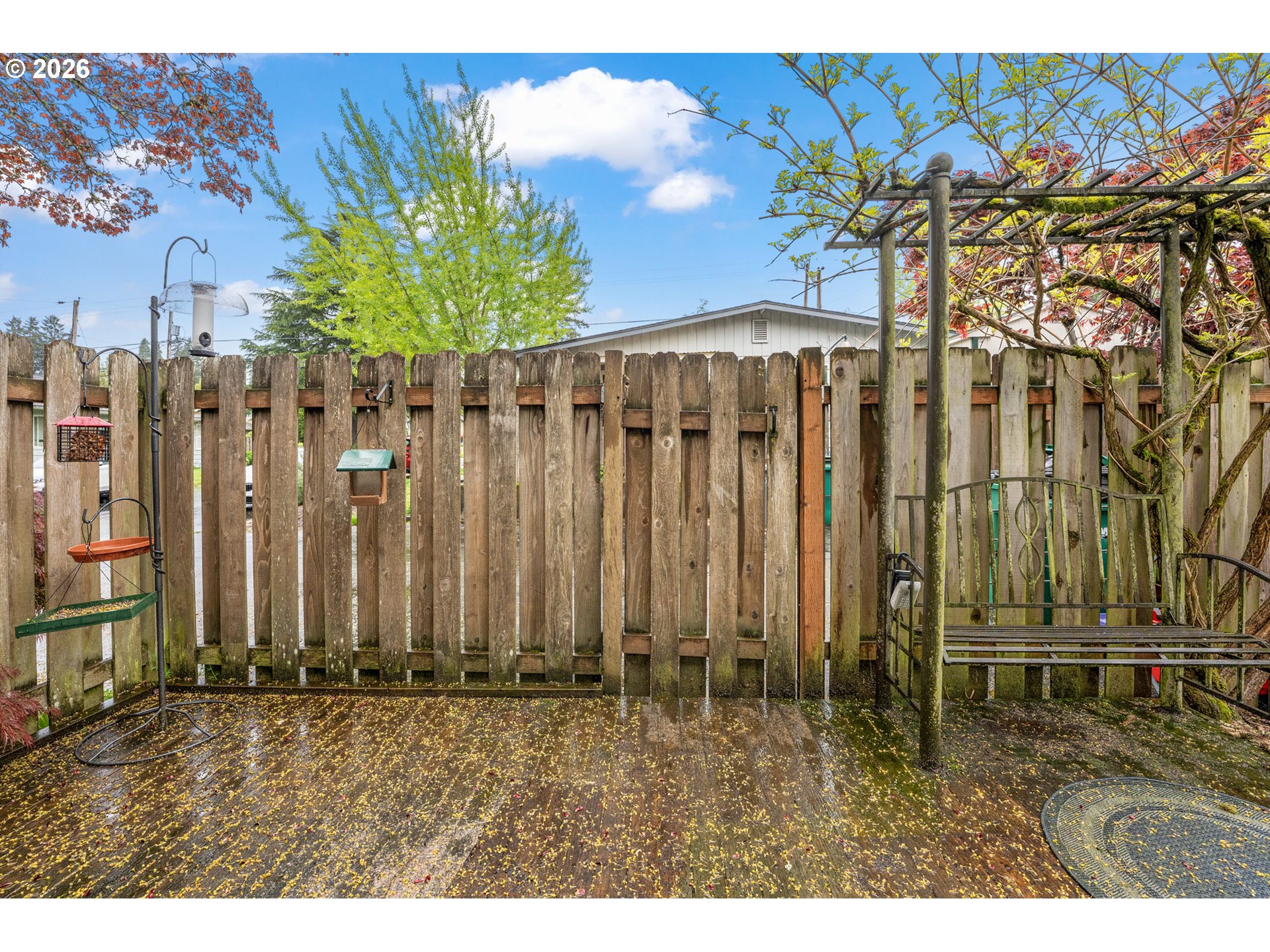 5566 Southwest Erickson Avenue Beaverton, OR 97005 - Photo 25 of 31 a view of a backyard with potted plants and wooden fence