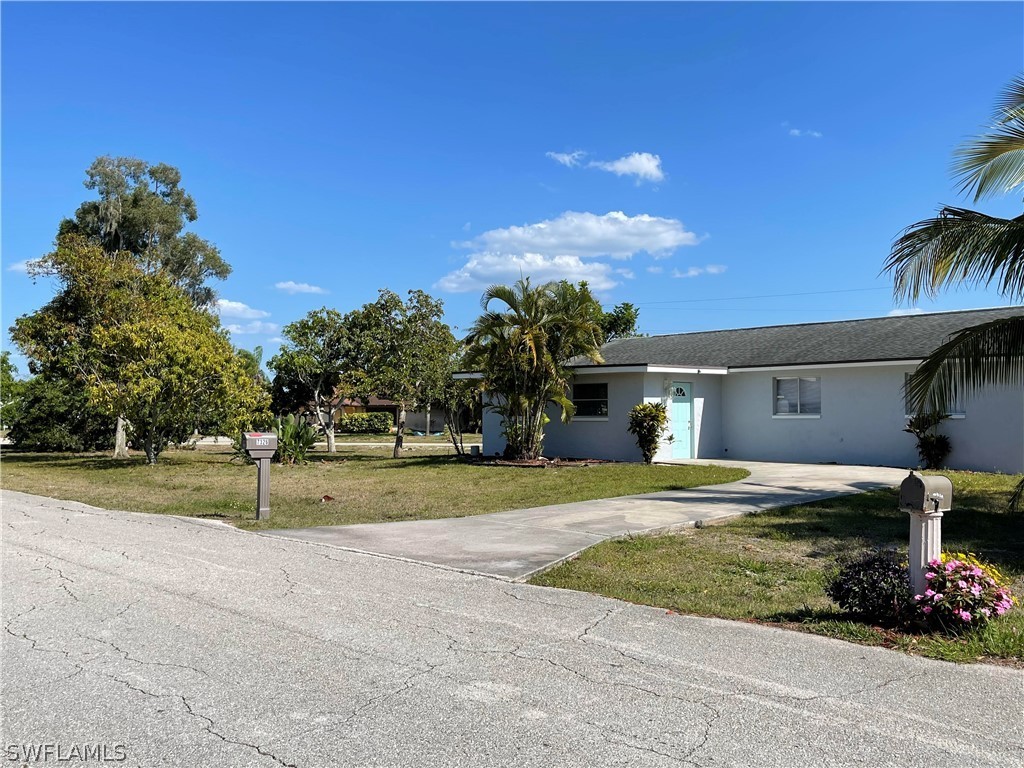 7326 Lobelia Road Fort Myers, FL 33967 - Photo 1 of 1 a view of a house with a backyard and a garage