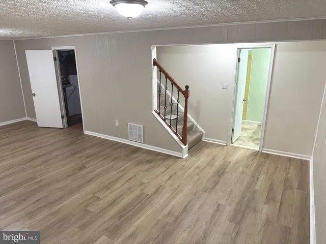a view of an entryway with wooden floor
