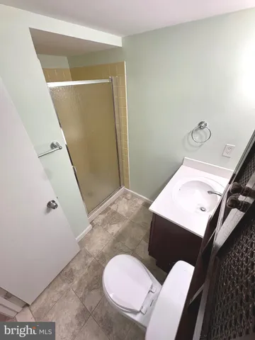 a bathroom with a sink mirror vanity and toilet
