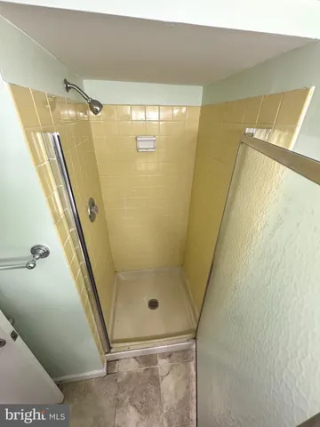 a bathroom with a glass door shower and toilet