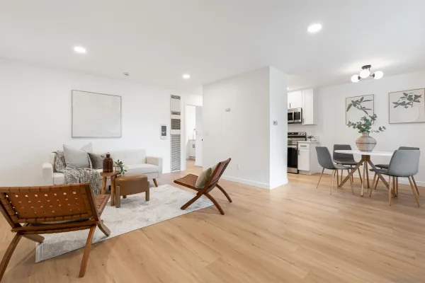 a living room with furniture and a wooden floor