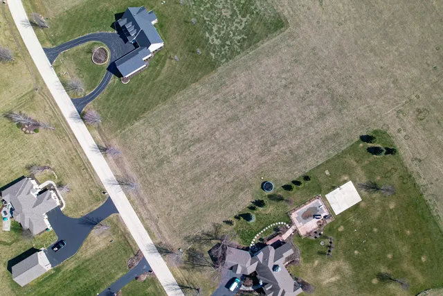 a backyard of a house with lots of green space and furniture