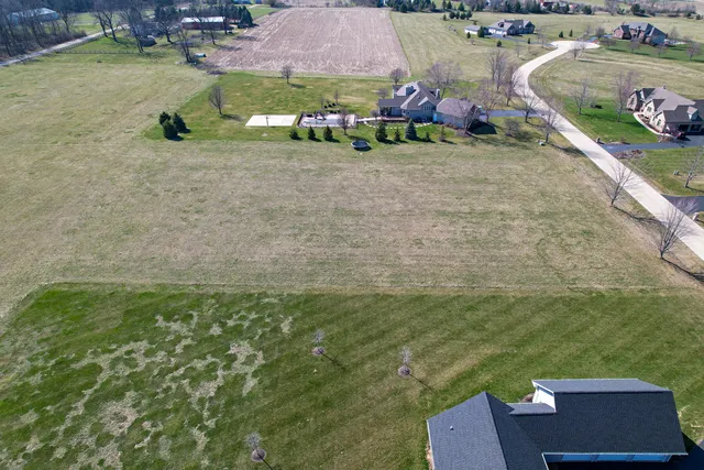 an aerial view of a house with a yard