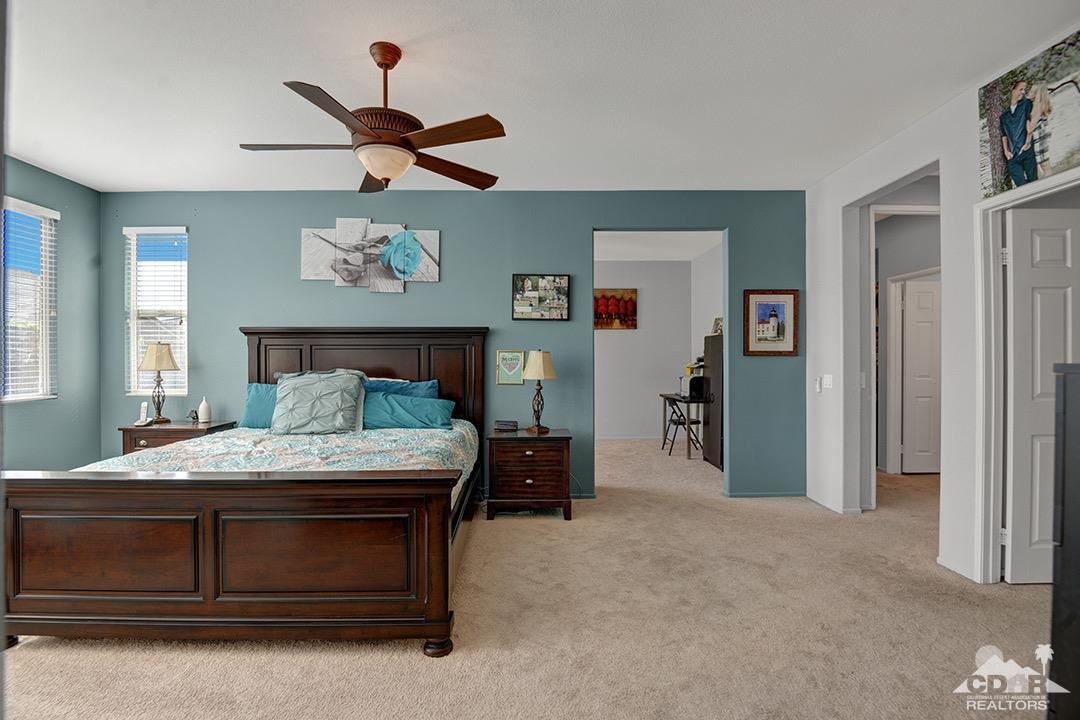 37388 Haweswater Road Indio, CA 92203 - Photo 11 of 28 a bedroom with a bed and a chandelier