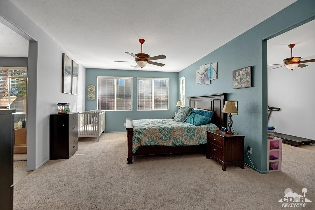 37388 Haweswater Road Indio, CA 92203 - Photo 13 of 28 a bedroom with a bed and a chandelier