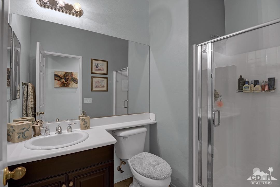 37388 Haweswater Road Indio, CA 92203 - Photo 21 of 28 a bathroom with a toilet a sink and mirror