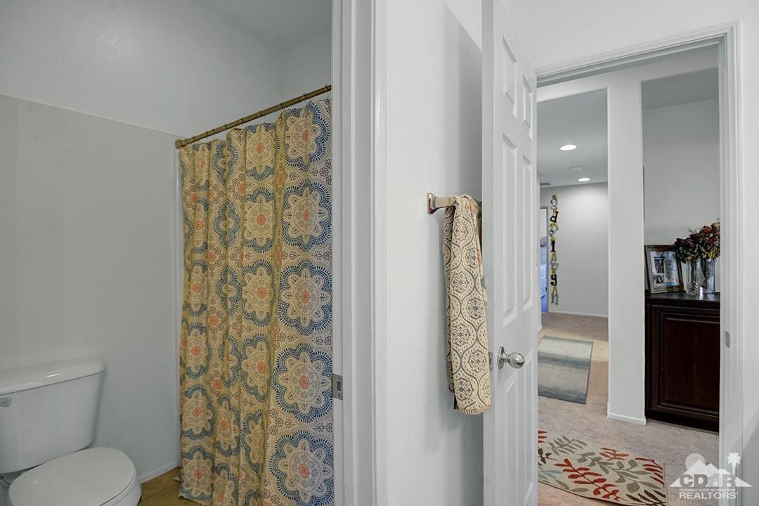 37388 Haweswater Road Indio, CA 92203 - Photo 22 of 28 a bathroom with a shower and a toilet