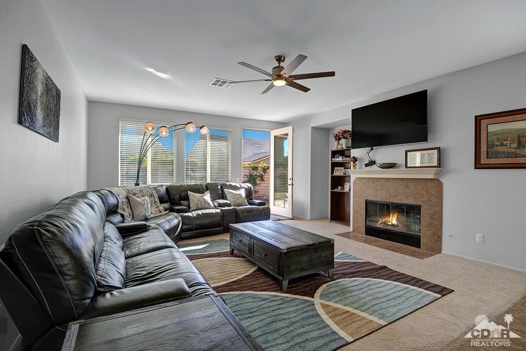 37388 Haweswater Road Indio, CA 92203 - Photo 4 of 28 a living room with furniture a flat screen tv and a fireplace