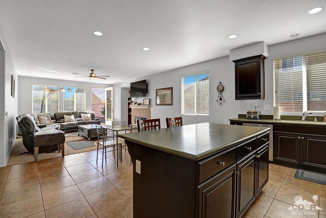 37388 Haweswater Road Indio, CA 92203 - Photo 8 of 28 a kitchen with a stove a sink a counter top space and living room view