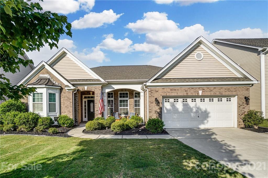 827 Solandra Way Fort Mill, SC 29708 - Photo 1 of 43 a view of a white house next to a yard with potted plants