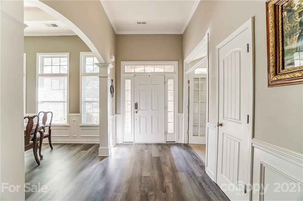 827 Solandra Way Fort Mill, SC 29708 - Photo 2 of 43 a view of front door with dining room and wooden floor