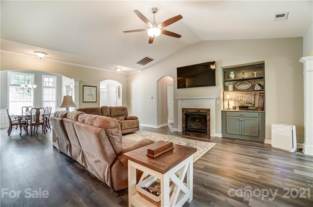 827 Solandra Way Fort Mill, SC 29708 - Photo 11 of 43 a living room with furniture a fireplace and a flat screen tv