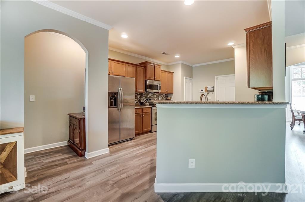 827 Solandra Way Fort Mill, SC 29708 - Photo 17 of 43 a kitchen with stainless steel appliances granite countertop a refrigerator a sink a stove a microwave and island