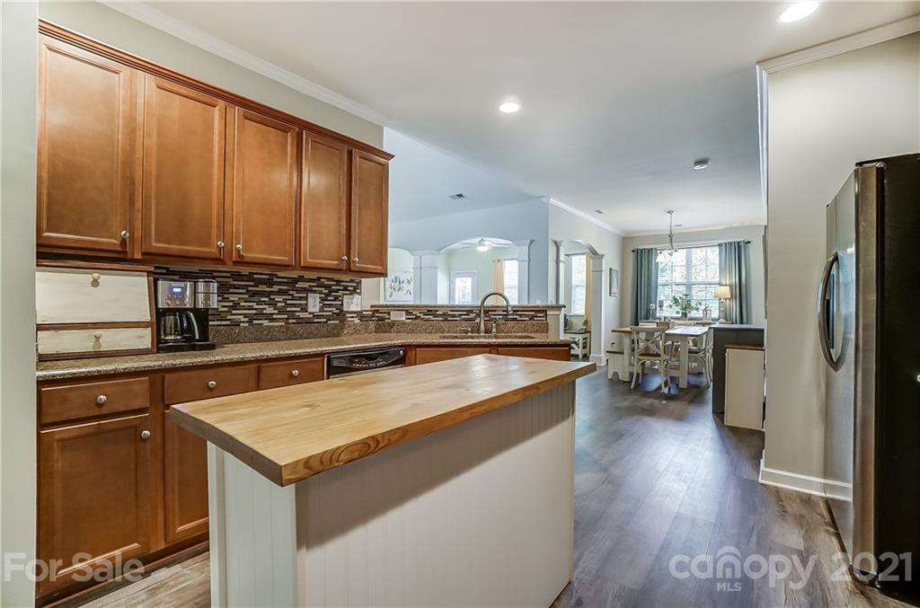 827 Solandra Way Fort Mill, SC 29708 - Photo 21 of 43 a kitchen with a refrigerator a sink dishwasher stove and oven with wooden floor