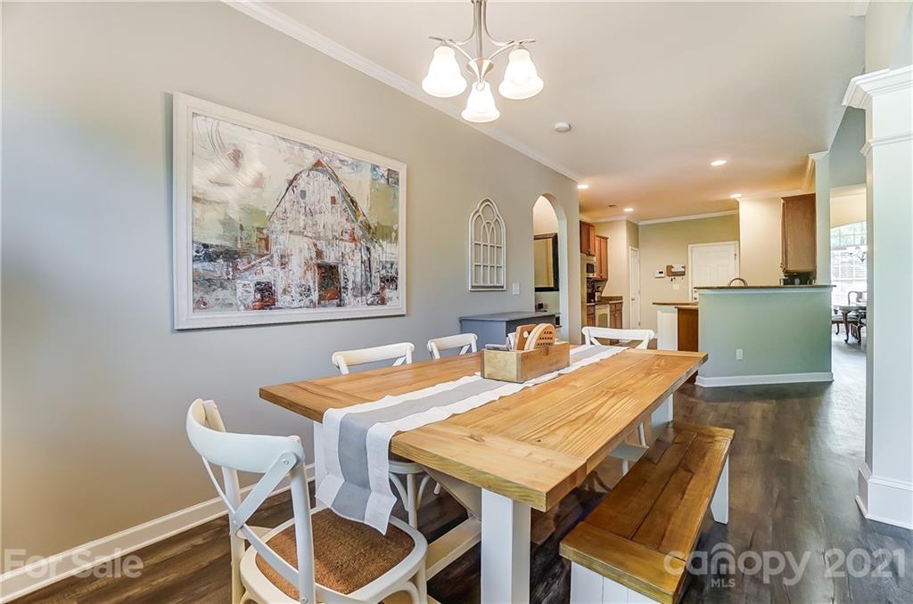 827 Solandra Way Fort Mill, SC 29708 - Photo 25 of 43 a view of a dining room with furniture and wooden floor