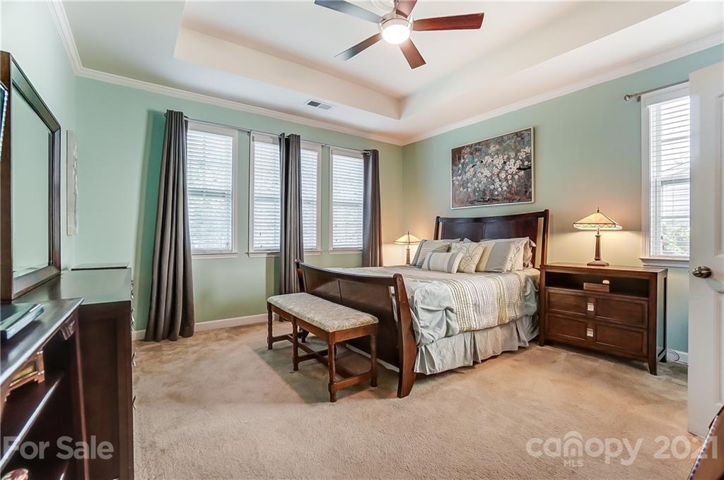 827 Solandra Way Fort Mill, SC 29708 - Photo 27 of 43 a bedroom with a bed and a chandelier