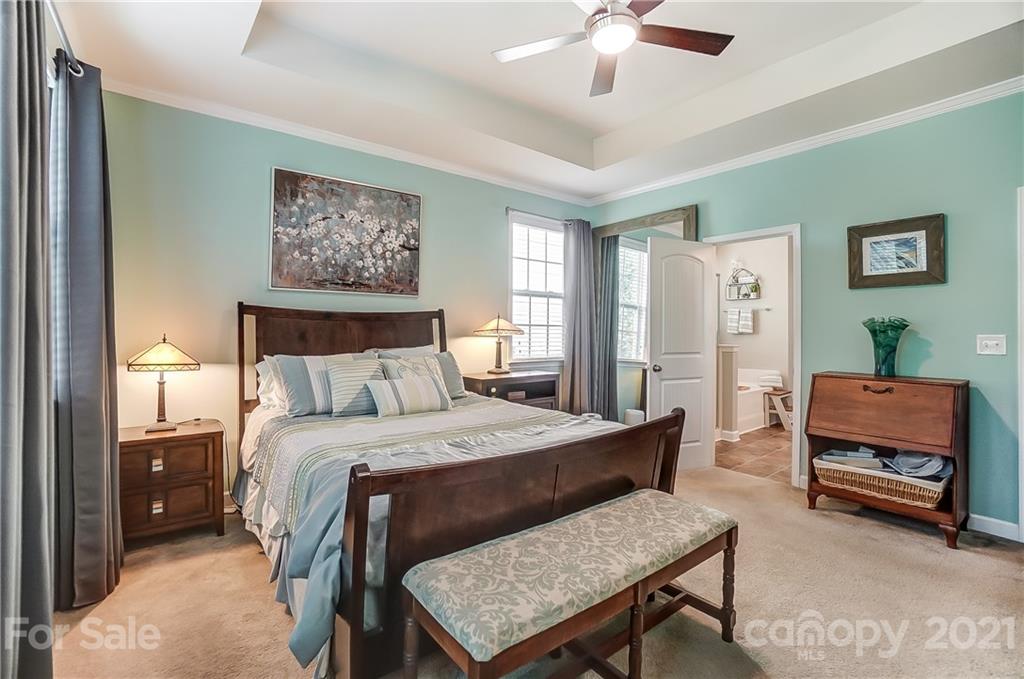 827 Solandra Way Fort Mill, SC 29708 - Photo 28 of 43 a bedroom with a bed and a chandelier