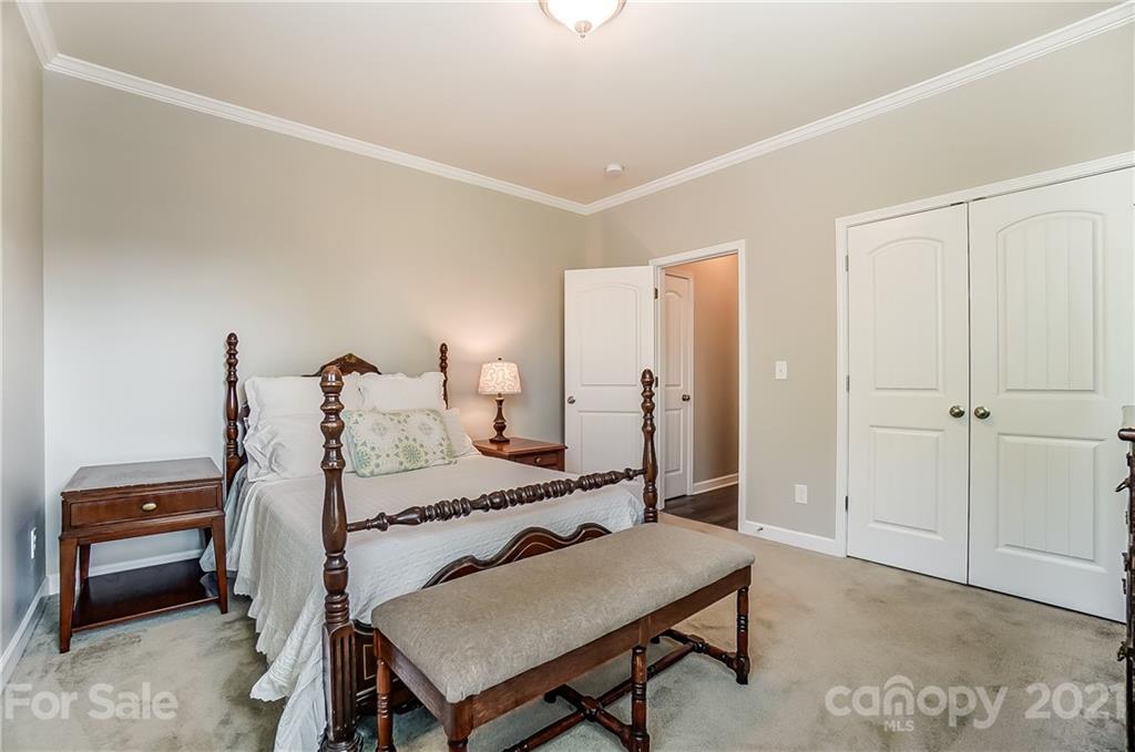 827 Solandra Way Fort Mill, SC 29708 - Photo 32 of 43 a bedroom with a bed and a dresser in it