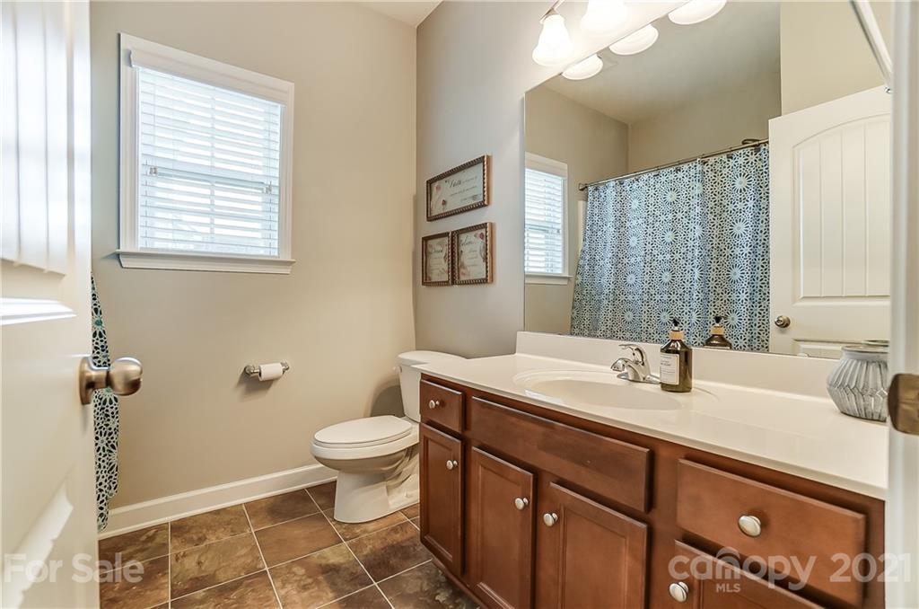 827 Solandra Way Fort Mill, SC 29708 - Photo 33 of 43 a bathroom with a sink a toilet and a mirror