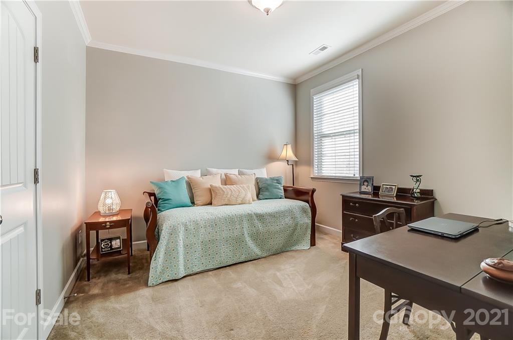 827 Solandra Way Fort Mill, SC 29708 - Photo 34 of 43 a bedroom with a bed and a table