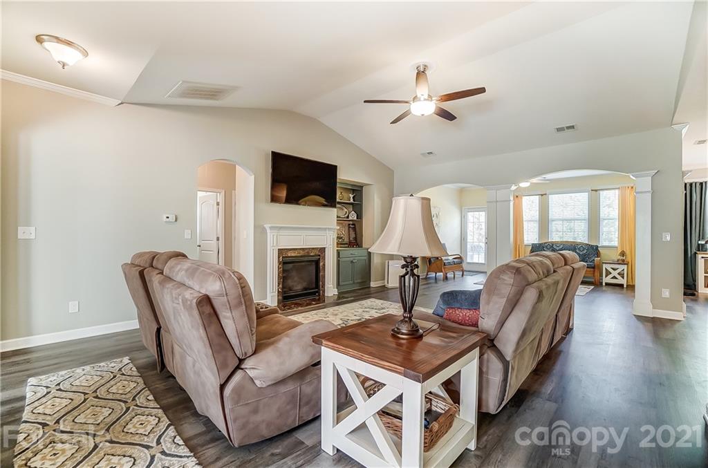 827 Solandra Way Fort Mill, SC 29708 - Photo 8 of 43 a living room with furniture a fireplace and a flat screen tv