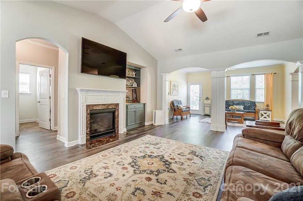 827 Solandra Way Fort Mill, SC 29708 - Photo 10 of 43 a living room with furniture a flat screen tv and a fireplace