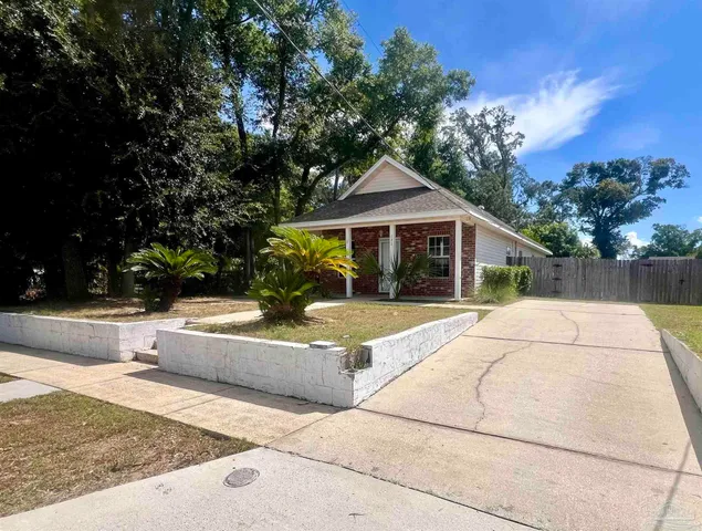 a view of house with yard and entertaining space