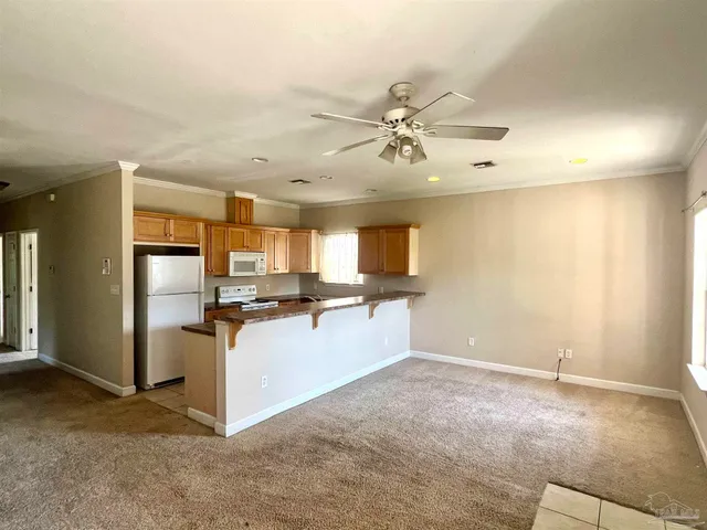a view of a kitchen with a sink and a refrigerator