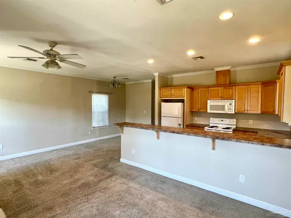 a view of a kitchen with a sink and living room view