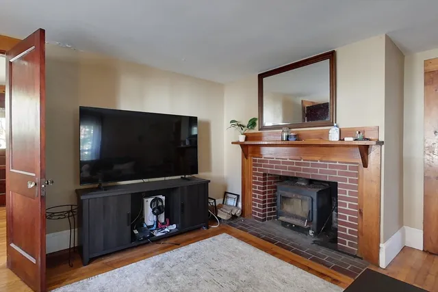 a living room with a fireplace and a flat screen tv