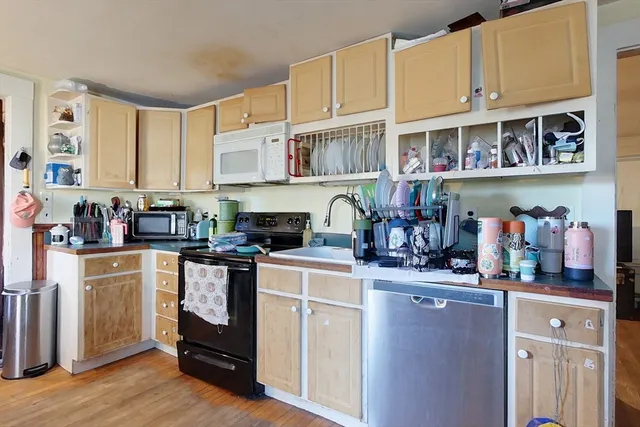 a kitchen with stainless steel appliances granite countertop a stove and cabinets