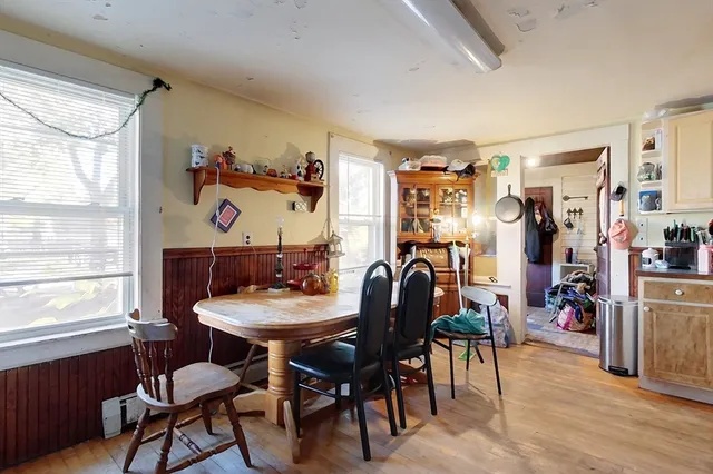 a view of a dining room with furniture and a window