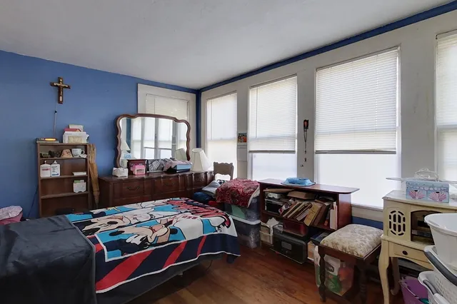 a bedroom with a bed window and couch