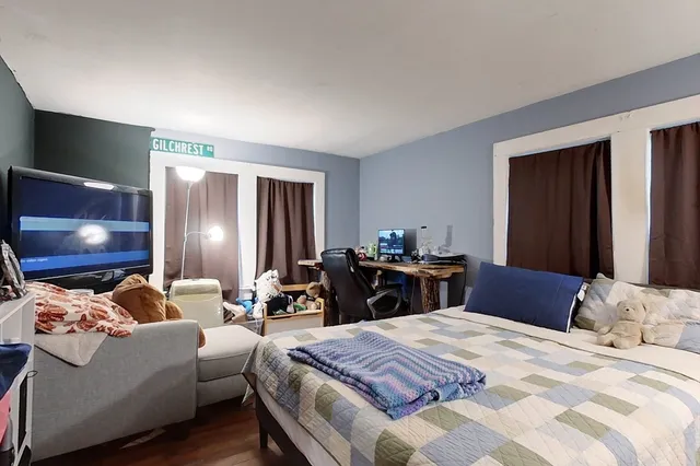 a bedroom with bed and a flat screen tv