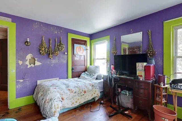 a bedroom with a bed and a flat screen tv