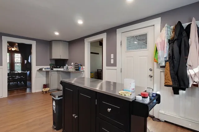 a kitchen with stainless steel appliances kitchen island granite countertop a refrigerator and a sink