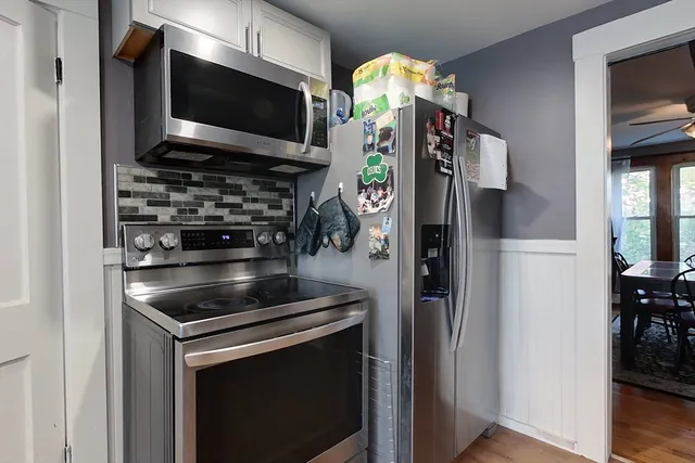 a kitchen with stainless steel appliances a stove and a microwave