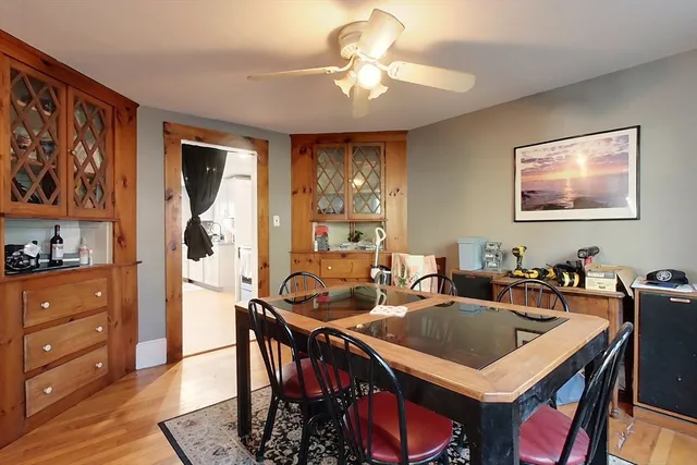 a view of a a dining room with furniture window and wooden floor