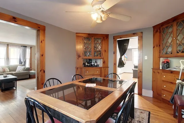 a kitchen with a table chairs sink and cabinets