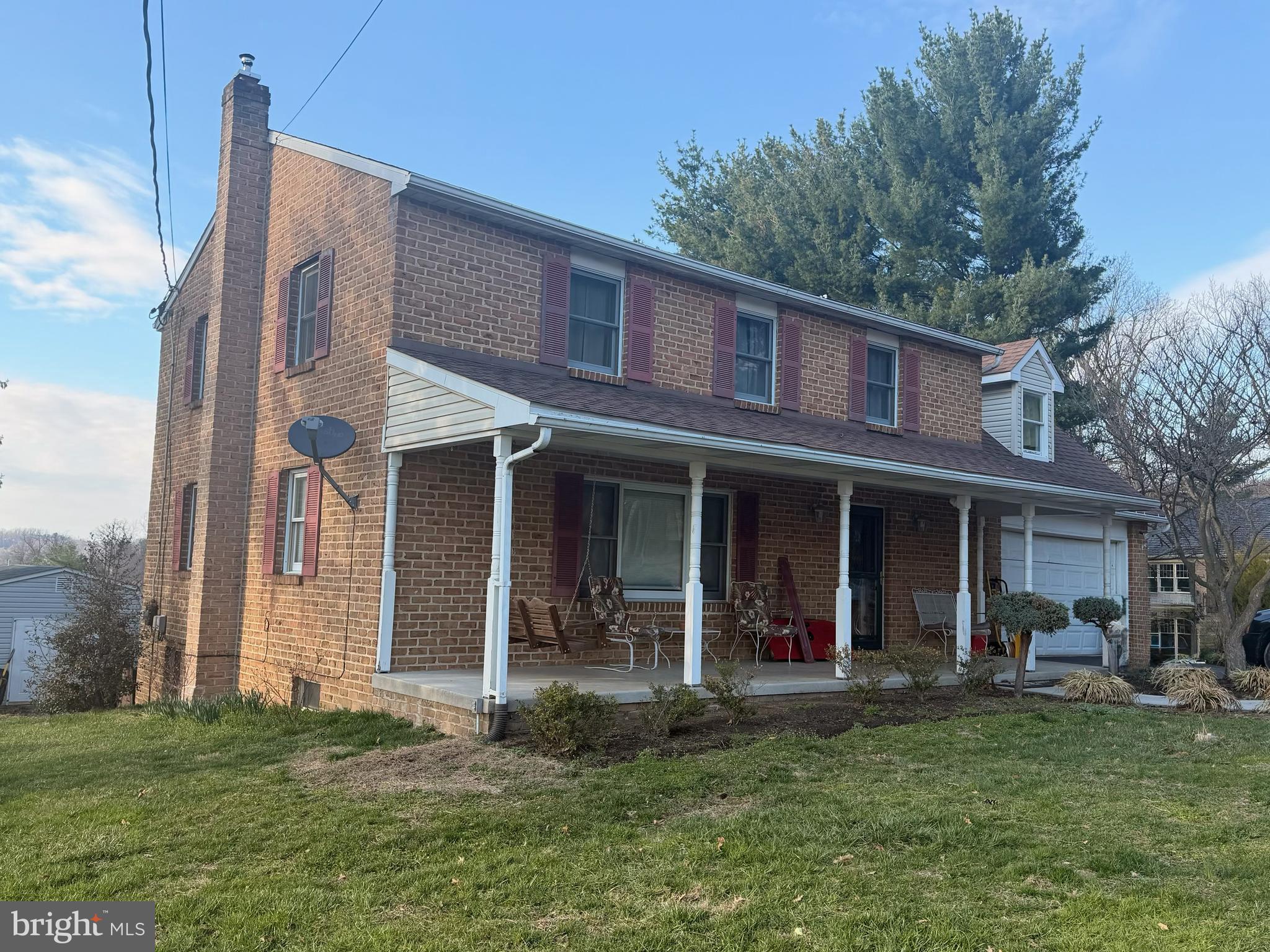 1065 Beaver Creek Road Hanover, PA 17331 - Photo 2 of 3 a view of a brick house with many windows plants and large trees
